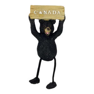 Black bear magnet holding Canada board sign